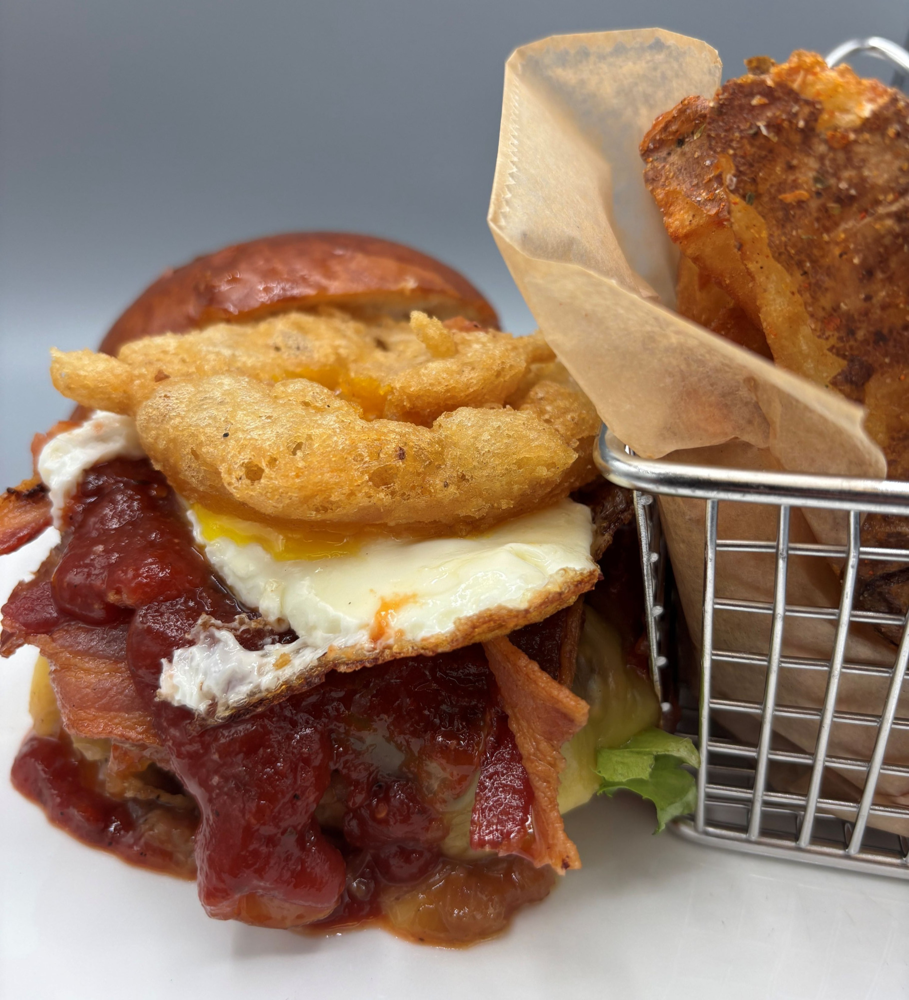 BFC Bourbon BBQ Burger beef burger | sunny side egg | onion ring | bacon jam | tomato | bourbon BBQ sauce | gouda cheese | brioche bun $22